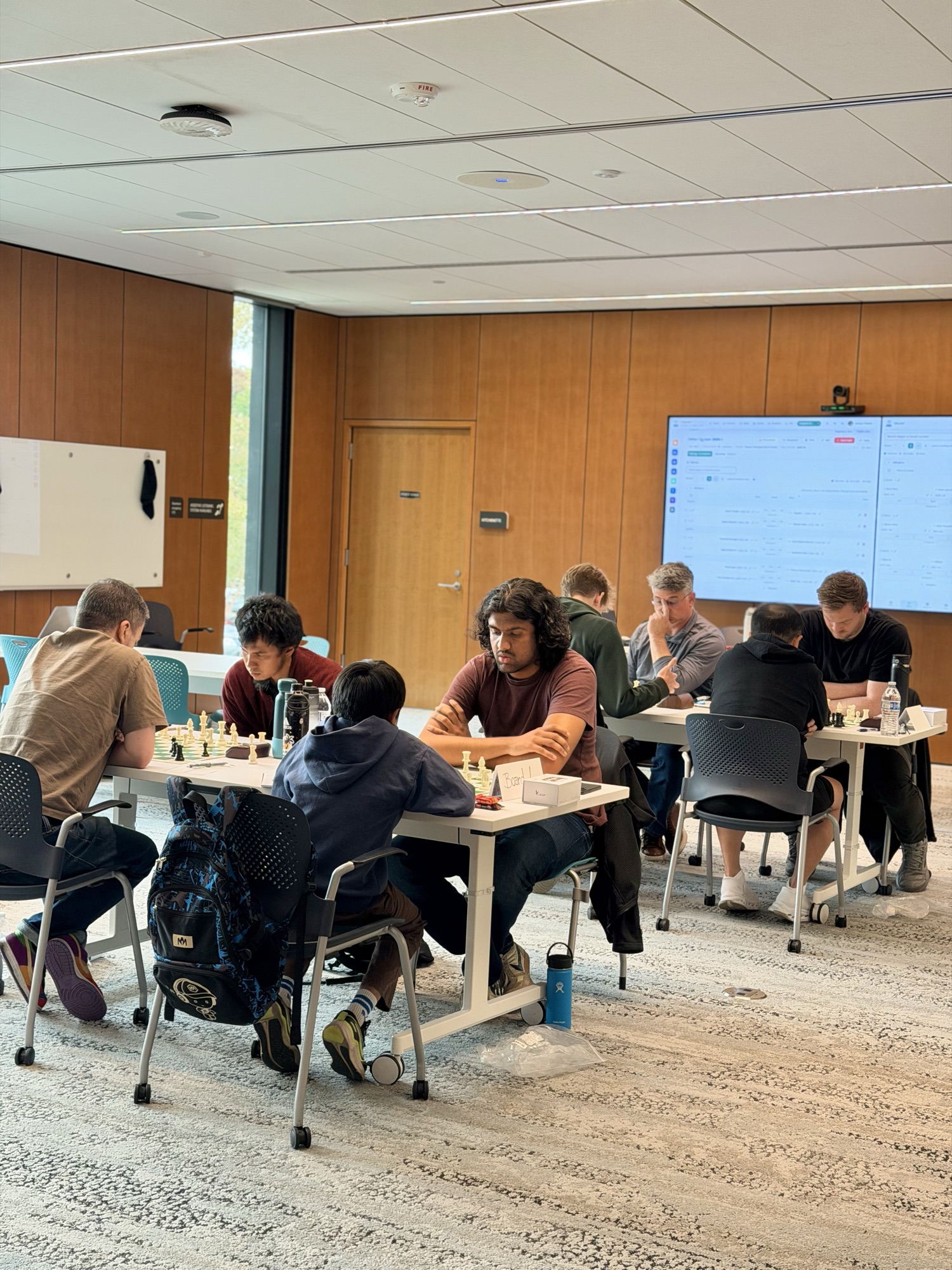 Players competing in quads one and two with the live tournament display visible behind them.