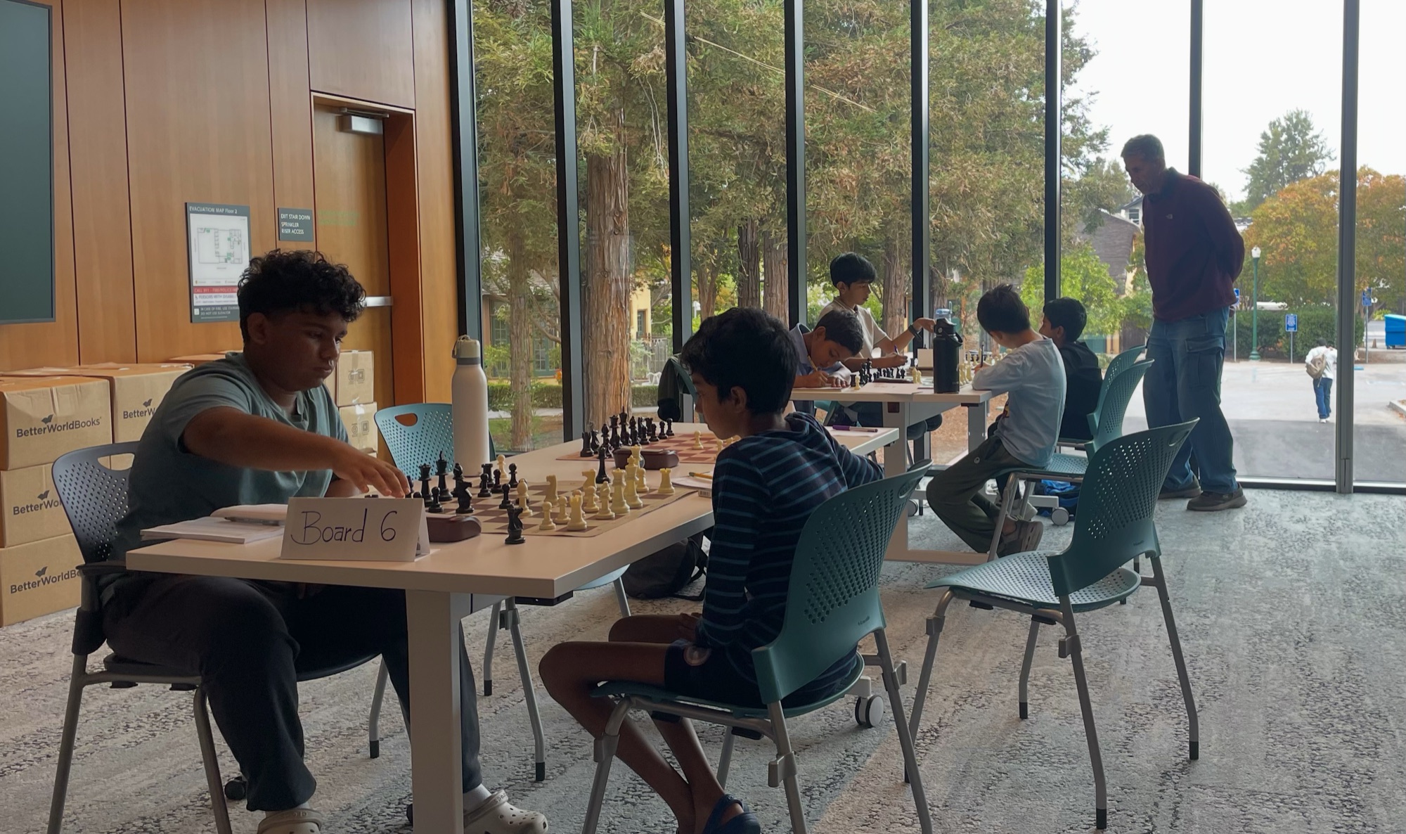 Players at the chessboards beside the windows during C4 x SMC.