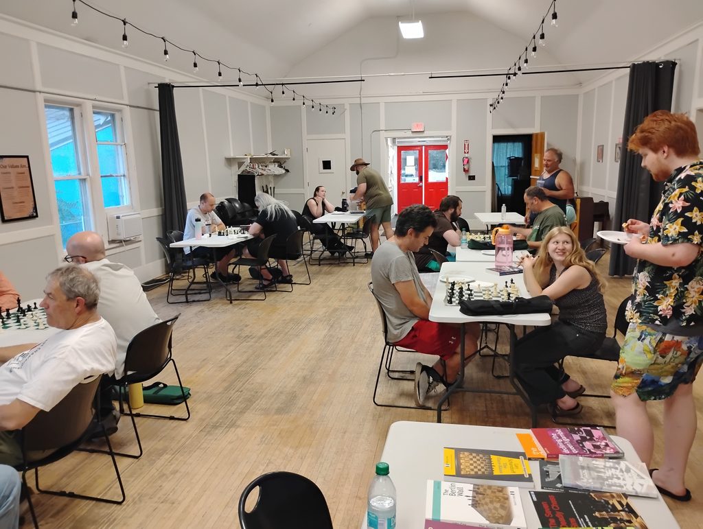 Chess players at tables across the Spokane Chess Club room.