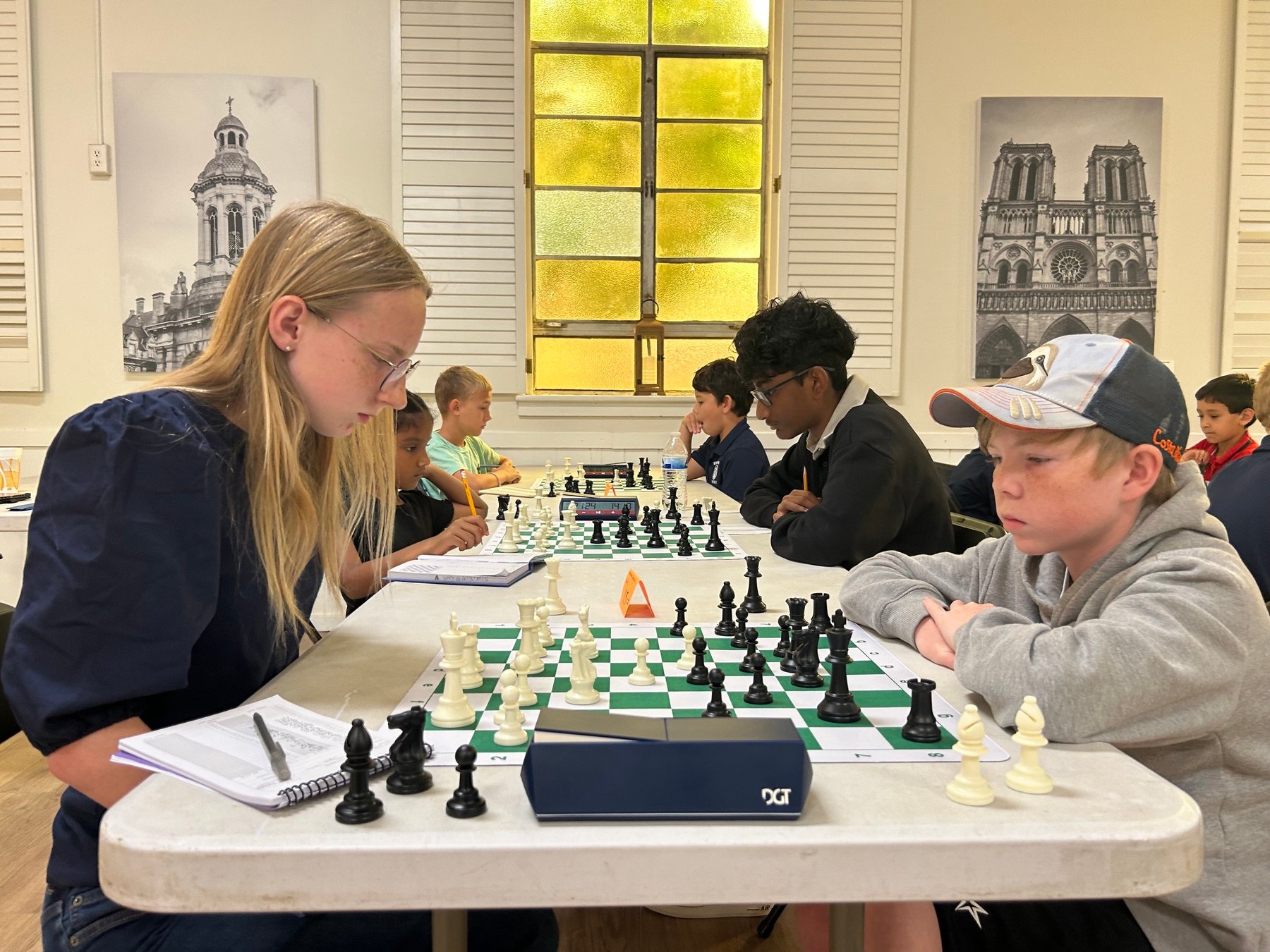 Two young players focused on a game at the Stonehaven scholastic tournament.